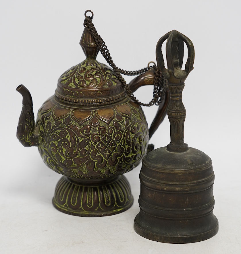 A 19th century Tibetan bronze ghanta bell and a 19th century Tibetan repousse copper teapot, tallest 18cm. Condition - fair to good